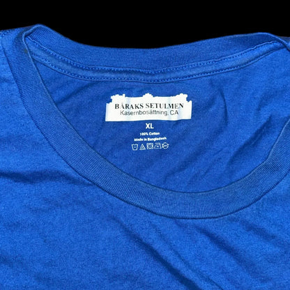 Blue t-shirt with a label on a wooden surface