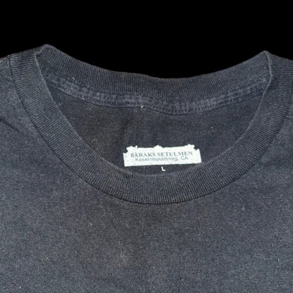 Black t-shirt with a brand label on a wooden surface